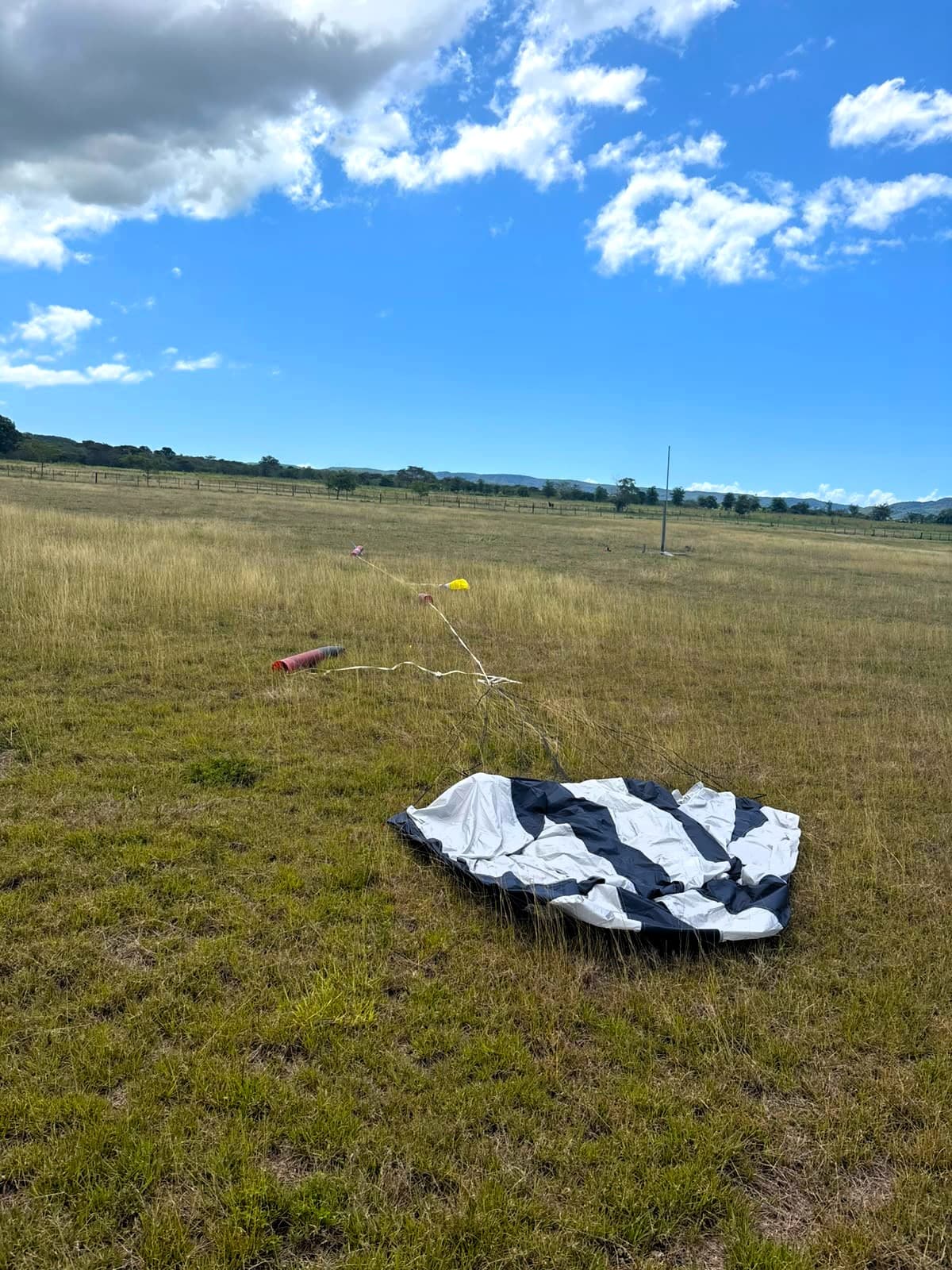 Rocket and parachutes laid out on the ground for post-flight inspection