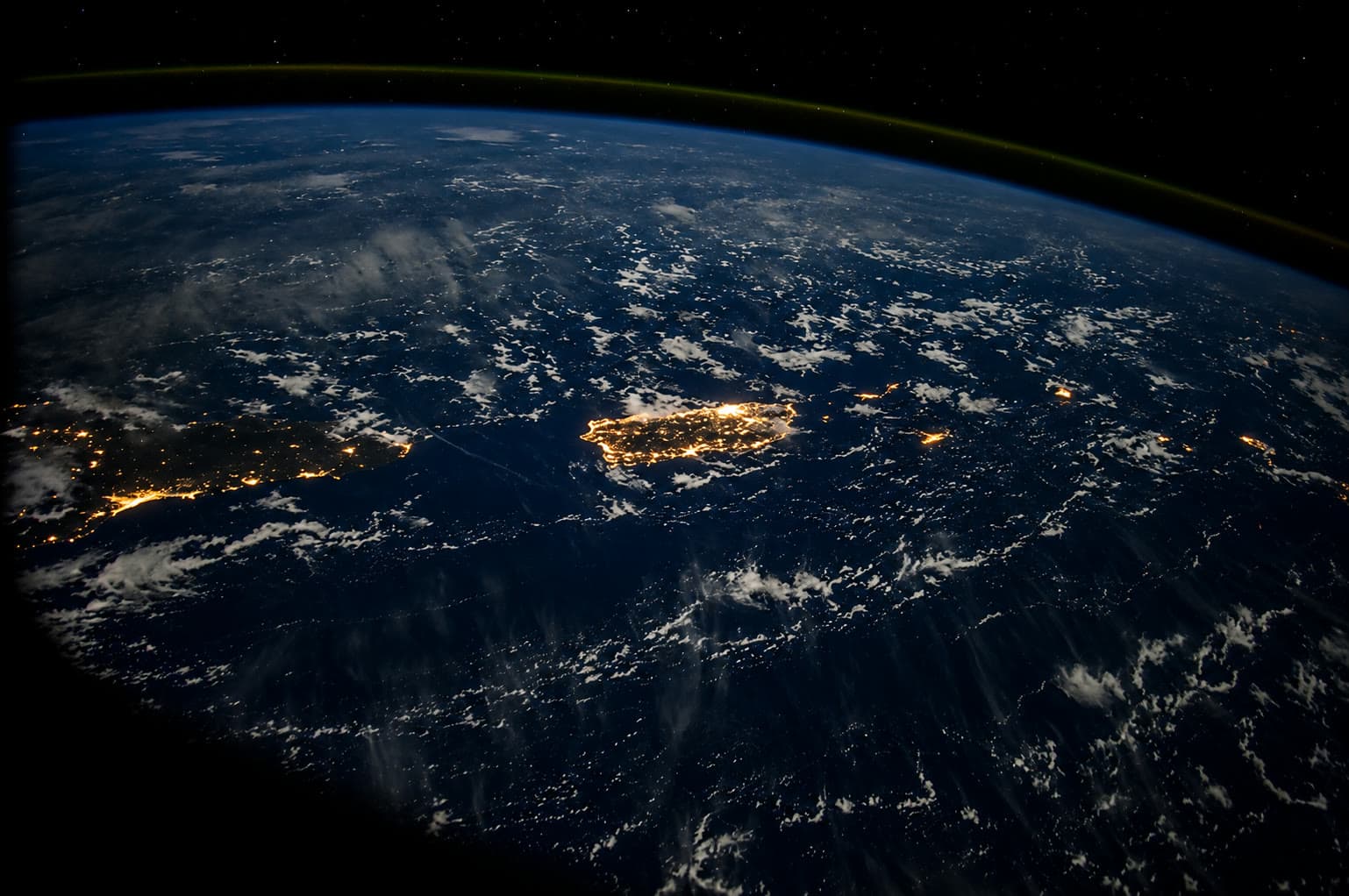 Nighttime satellite view of Puerto Rico's city lights from orbit