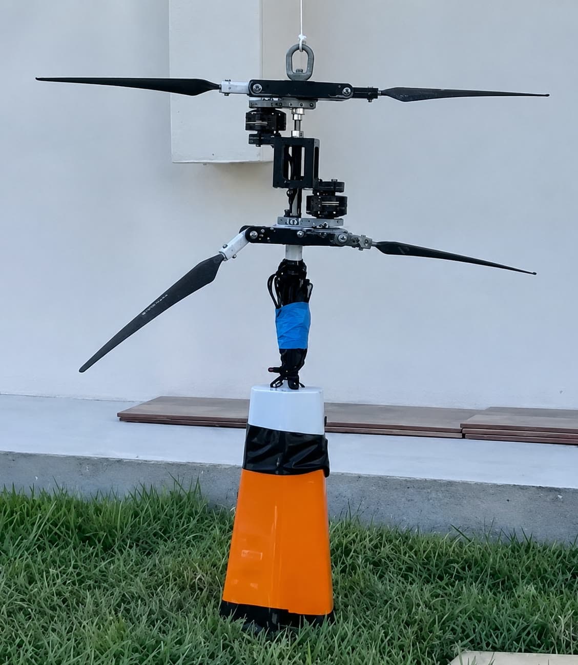 The assembled C.H.I.L.D. coaxial-helicopter payload standing upright on its orange housing during an outdoor ground test.