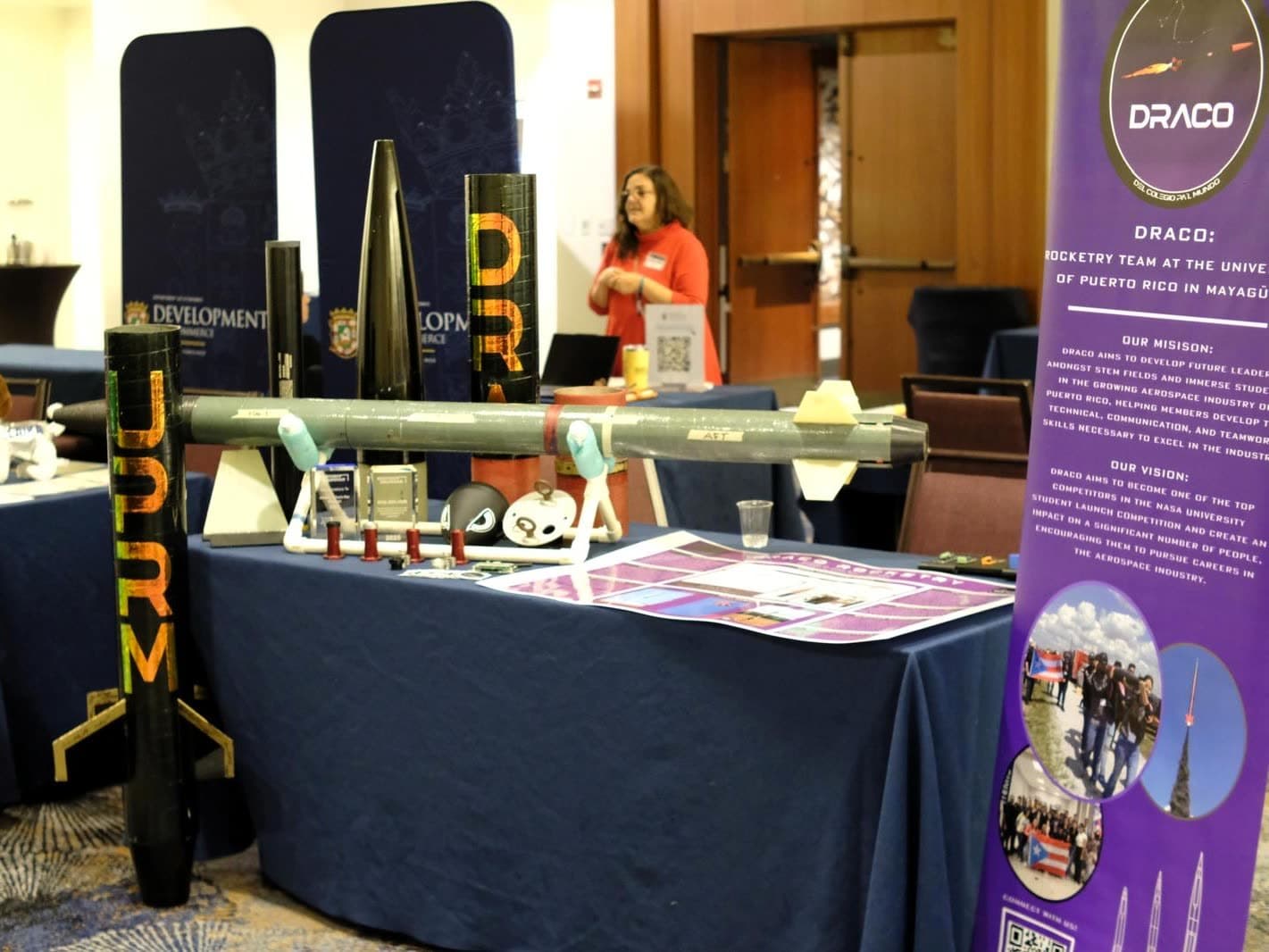 DRACO's exhibition table with rocket hardware and the team's mission banner