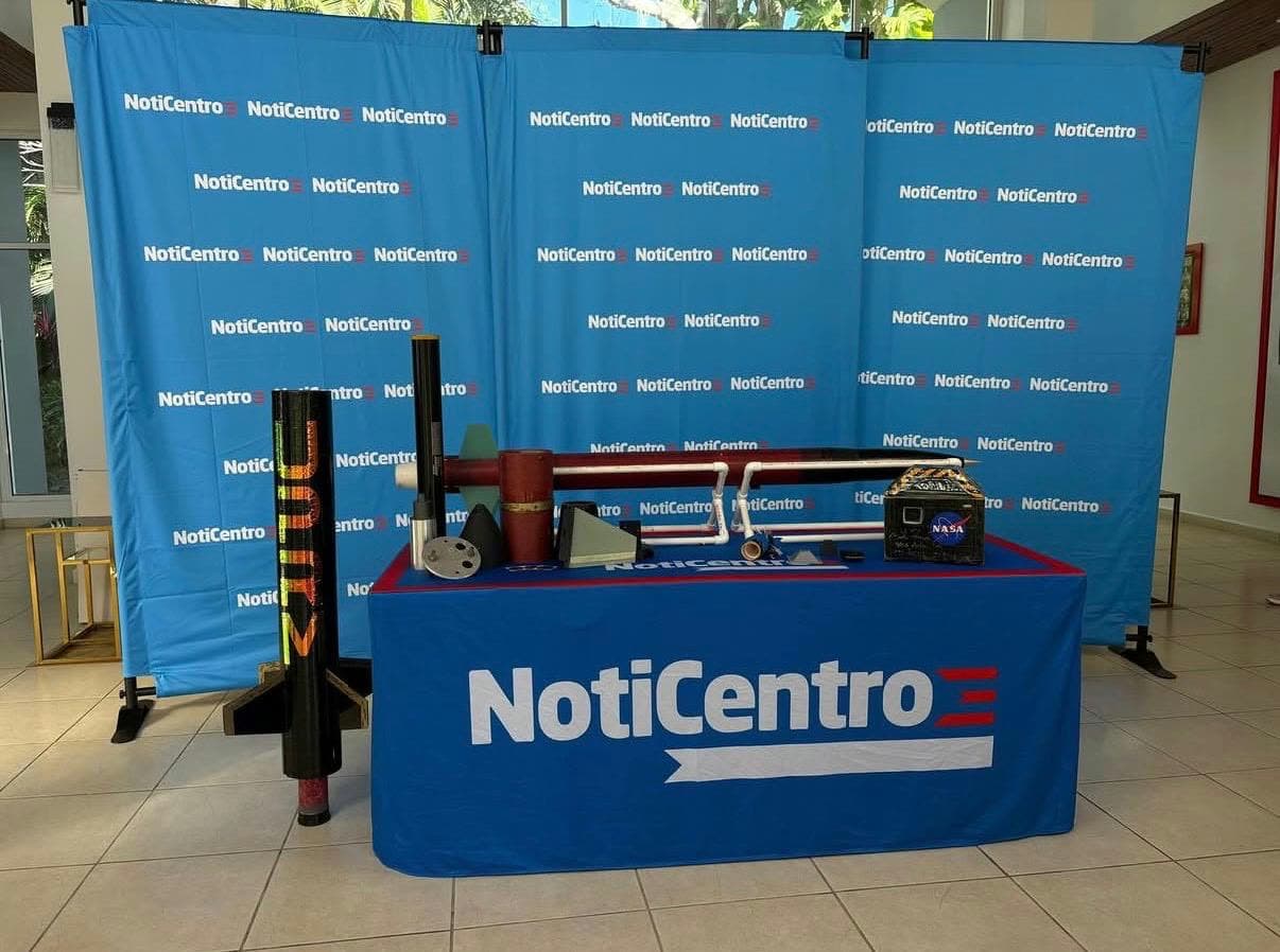 DRACO rocket components and payload hardware displayed on a NotiCentro table for a media appearance